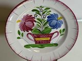 a plate with flowers on it sitting on a table