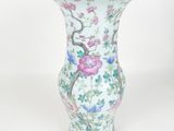 a vase with a bird and flowers on it on a white background