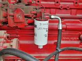 a close up of a red truck engine with a hose