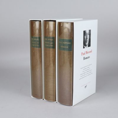 three books are stacked on top of each other on a table
