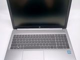 a silver laptop with a black screen sitting on a white surface