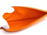 an orange purse with a zipper on a white background