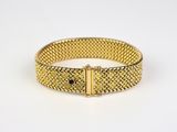 a gold mesh bracelet with a clasp