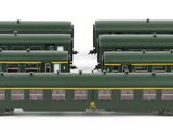 three green train cars sitting next to each other on a white surface