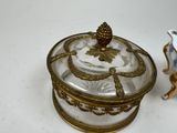 a glass box with a lid and a figurine on a table