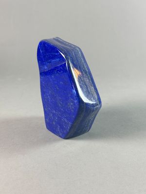 a close up of a blue stone on a white surface