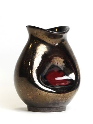 a black and red vase sitting on a white surface