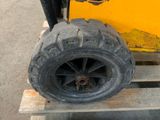 a tire that is sitting on a pallet next to a fork