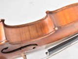 a close up of a violin on a stand