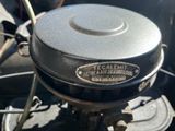 a close up of a motorcycle engine with a metal cover