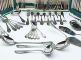 a green case with silverware in it on a white surface