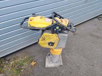 a yellow and black machine that is sitting on the ground