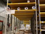 many boxes of toilet paper on the shelves in the warehouse