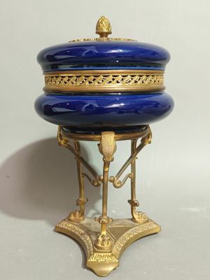 a blue and gold box sitting on top of a stand