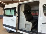a white van with the door open in a garage