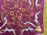 a purple scarf with gold chains and chains on it