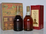 two bottles of liquor are sitting next to a box of wine