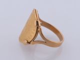 a close up of a gold ring on a white surface