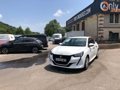 a white car parked in front of a building in a parking lot
