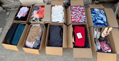 many boxes of clothes that are sitting on the ground