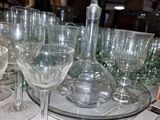 bottles and glasses are lined up on a tray on a table