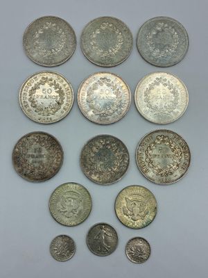 un ensemble de pièces d'argent et de pièces en argent posées sur une surface blanche
