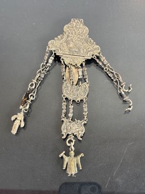 an image of a silver and gold necklace with a cross on it