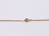 a close up of a gold chain on a white background