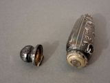 a small silver object next to a smaller silver object