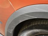 a close up of a car tire with a cat sitting on it