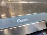 a close up view of a toaster oven with the words banzaher on it