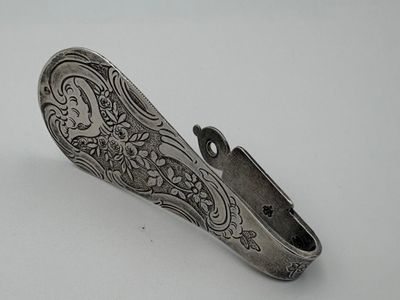 an antique silver plated pocket knife on a white surface