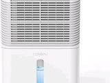 a white air conditioner sitting on top of a white table