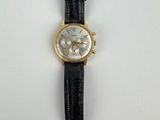 a close up of a watch on a white surface with a black strap