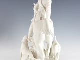 a statue of a man riding a horse with a dog