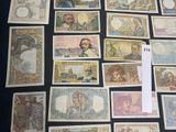a lot of different types of paper money on the table