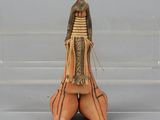a small figurine of a woman sitting on the ground