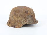 a rusty helmet on a white surface
