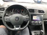 the interior of a car with a steering wheel and dashboard controls