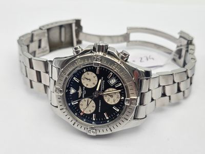 a watch that is sitting on a white surface