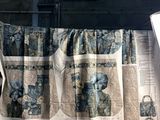 a quilt on a table next to a window