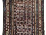 an antique persian rug with a geometric design on a white background
