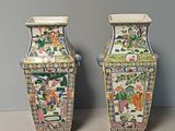 two vases sitting next to each other on a table