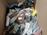 a cardboard box filled with many different types of clothing