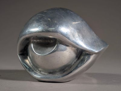 a silver sculpture of a shell on a table