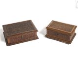 two wooden boxes with carvings on them sitting next to each other