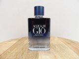 the bottle of acqua di gio is sitting on a wooden table