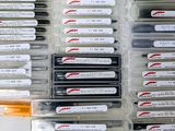 many different types of pens in a plastic case