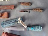 many different types of knives on the table