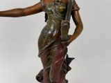 bronze statue of a woman holding an umbrella on a marble base